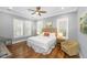 Bedroom with a ceiling fan, shuttered windows, hardwood floors and neutral tones create a cozy and inviting atmosphere at 2932 Old Drake Dr, Seabrook Island, SC 29455