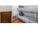 This room offers a metal frame bunk bed, wood floors, and a chest of drawers for storage at 2932 Old Drake Dr, Seabrook Island, SC 29455