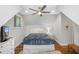 Well-lit bedroom with a ceiling fan, hardwood floors, and two windows at 2932 Old Drake Dr, Seabrook Island, SC 29455