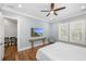 Bedroom with a coastal view on a flat-screen TV with plantation shutters and a ceiling fan at 2932 Old Drake Dr, Seabrook Island, SC 29455