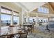 Bright dining room featuring a large window overlooking the coast with multiple tables and chairs at 2932 Old Drake Dr, Seabrook Island, SC 29455