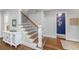 Elegant foyer with hardwood floors, staircase with decorative iron railing, and stylish decor at 2932 Old Drake Dr, Seabrook Island, SC 29455