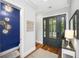 Stylish foyer boasts hardwood floors, elegant front door, and a convenient powder room at 2932 Old Drake Dr, Seabrook Island, SC 29455