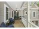 Inviting front porch features comfortable seating, stylish decor, and views of the home's exterior at 2932 Old Drake Dr, Seabrook Island, SC 29455