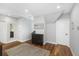Bright hallway with wood floors, cabinet, rug, and neutral wall colors at 2932 Old Drake Dr, Seabrook Island, SC 29455