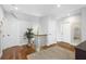 Well-lit hallway with hardwood floors, potted plants, and modern decor at 2932 Old Drake Dr, Seabrook Island, SC 29455