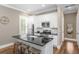 Well-lit kitchen boasts modern appliances, white cabinetry, a black countertop, and a cozy breakfast bar at 2932 Old Drake Dr, Seabrook Island, SC 29455
