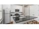 Modern kitchen features stainless steel appliances, white cabinets, and a black granite countertop with bar stool seating at 2932 Old Drake Dr, Seabrook Island, SC 29455