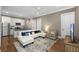 Living room featuring white couch, black countertops, and an adjacent kitchen at 2932 Old Drake Dr, Seabrook Island, SC 29455