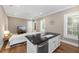 Living room showcasing a kitchen island, white sofa, television, hardwood floors, and natural light at 2932 Old Drake Dr, Seabrook Island, SC 29455