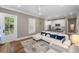 Bright and airy living area with a plush sofa, large windows, and an open layout to the kitchen at 2932 Old Drake Dr, Seabrook Island, SC 29455