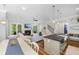 Open-concept living room with fireplace, kitchen island, and dining table at 2932 Old Drake Dr, Seabrook Island, SC 29455
