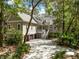 Charming exterior of a home with a two-car garage, porch, and beautiful surrounding landscape at 2932 Old Drake Dr, Seabrook Island, SC 29455