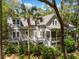 Beautiful exterior home view featuring a large porch, lush green plants, and a palm tree at 2932 Old Drake Dr, Seabrook Island, SC 29455