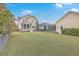 Expansive backyard with lush grass, mature trees, and a charming patio area at 3713 Maidstone Dr, Mount Pleasant, SC 29466