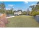 Spacious backyard features a well-manicured lawn and a fenced in yard with a fire pit area at 3713 Maidstone Dr, Mount Pleasant, SC 29466