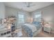 Light-filled bedroom featuring a ceiling fan, desk, and a cozy bed with patterned bedding at 3713 Maidstone Dr, Mount Pleasant, SC 29466