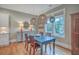 Charming dining area with a blue table, unique lighting, and hardwood floors at 3713 Maidstone Dr, Mount Pleasant, SC 29466