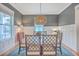 Bright dining room with blue rug, modern lighting, and a view from the window at 3713 Maidstone Dr, Mount Pleasant, SC 29466