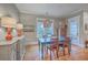 Cozy dining area featuring a painted wooden table, hardwood floors, and unique pendant lights at 3713 Maidstone Dr, Mount Pleasant, SC 29466