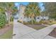 Lovely two-story yellow home featuring palm trees, a front porch and a driveway leading to a garage at 3713 Maidstone Dr, Mount Pleasant, SC 29466