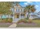 Charming yellow two-story home with a welcoming front porch and beautifully landscaped front yard at 3713 Maidstone Dr, Mount Pleasant, SC 29466