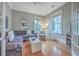 Inviting living room with hardwood floors, comfortable seating, and ample natural light from large windows at 3713 Maidstone Dr, Mount Pleasant, SC 29466