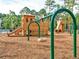 Community playground featuring wooden play structures, slides, and swings, set in a lush, wooded area at 3713 Maidstone Dr, Mount Pleasant, SC 29466