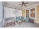 Charming screened-in porch with wicker seating, perfect for relaxing and entertaining at 3713 Maidstone Dr, Mount Pleasant, SC 29466
