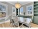 Dining room with abundant natural light, decorative chandelier, and custom built-in cabinets at 3859 Segars Lndg, Mount Pleasant, SC 29466