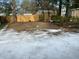 Backyard partially covered in snow with a wooden fence visible in the background at 5110 Temple St, North Charleston, SC 29405