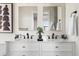 Sleek bathroom with double vanity, white cabinets, marble countertops, and stylish black fixtures at 5110 Temple St, North Charleston, SC 29405
