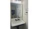 Bathroom showcasing a farmhouse style sink with black plumbing fixtures and framed mirror at 5110 Temple St, North Charleston, SC 29405