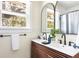 Modern double vanity bathroom with wood accents, sleek black fixtures, and an abundance of natural light at 5110 Temple St, North Charleston, SC 29405
