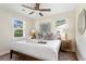 Bright and airy bedroom showcasing a king bed, ceiling fan, and large windows for natural light at 5110 Temple St, North Charleston, SC 29405