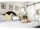 Stylishly appointed bedroom with a breakfast tray on the bed and unique barn door entrance at 5110 Temple St, North Charleston, SC 29405