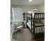Cozy bedroom featuring a bunk bed, accent chair, and decorative round rug at 5110 Temple St, North Charleston, SC 29405