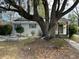 Charming single-story home with a beautifully landscaped front yard and mature trees at 5110 Temple St, North Charleston, SC 29405