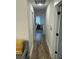 Hallway with wood-look flooring, neutral walls, and multiple doorways at 5110 Temple St, North Charleston, SC 29405