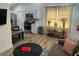 Open-concept living space featuring hardwood floors, modern decor, and a view into the kitchen at 5110 Temple St, North Charleston, SC 29405