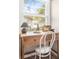 Work from home in style with this light filled office featuring a vintage wood desk and neutral colors at 5110 Temple St, North Charleston, SC 29405