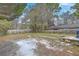 The large backyard with a mix of grass and leaves, a shed, and a wooden fence at 635 Sequoia St, Charleston, SC 29407