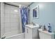 Bright bathroom features a vanity sink, toilet, and a shower with a blue patterned curtain at 635 Sequoia St, Charleston, SC 29407