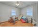 This bedroom features hardwood floors, a ceiling fan, and lots of natural light from two windows at 635 Sequoia St, Charleston, SC 29407