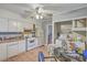 Kitchen with white appliances and cabinets, complemented by a ceiling fan and tile flooring at 635 Sequoia St, Charleston, SC 29407