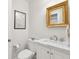 Bathroom with marble countertop, updated fixtures, and gilded mirror at 67 Legare St # 305, Charleston, SC 29401