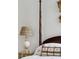 Close-up on an elegant bedroom featuring lamps on either side of a plush four-poster bed at 67 Legare St # 305, Charleston, SC 29401
