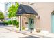 Charming entrance featuring a black awning, potted plants, and a bright, cheerful teal door at 67 Legare St # 305, Charleston, SC 29401