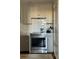 A stainless steel range hood with a tile backsplash in a modern kitchen at 67 Legare St # 305, Charleston, SC 29401