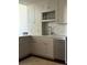 Well-organized kitchen featuring shaker cabinets, marble countertop, stainless steel dishwasher, and tile backsplash at 67 Legare St # 305, Charleston, SC 29401